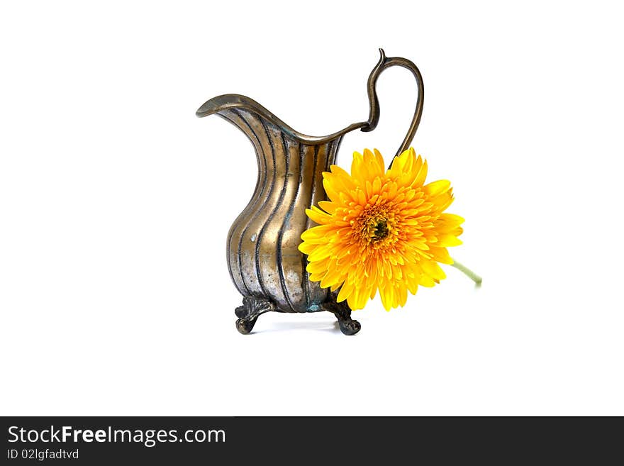 Ancient brass ewer with flower  on white background