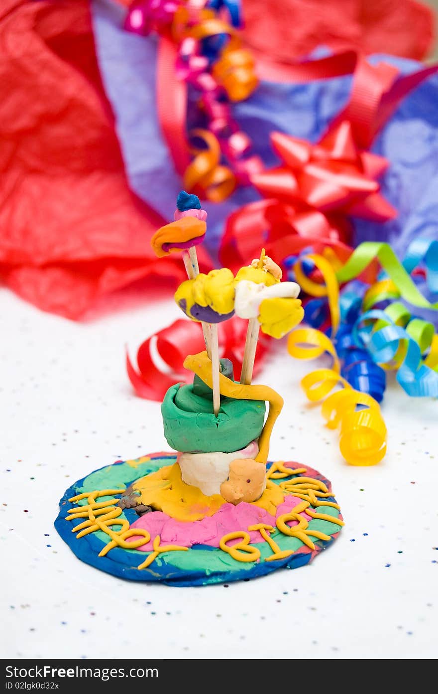 Child's self-made toy birthday cake with candles