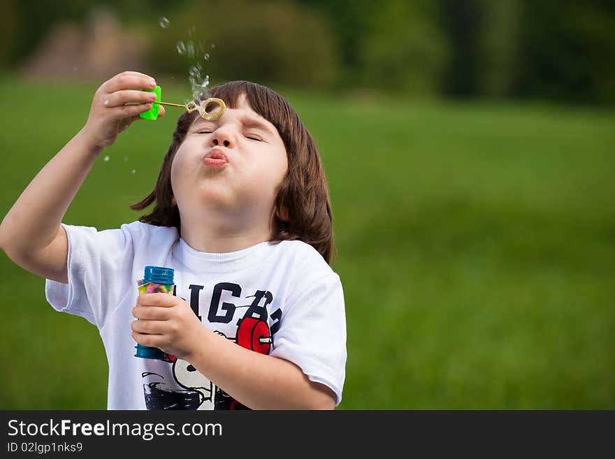 Boy tries to make a soap bubble. Boy tries to make a soap bubble