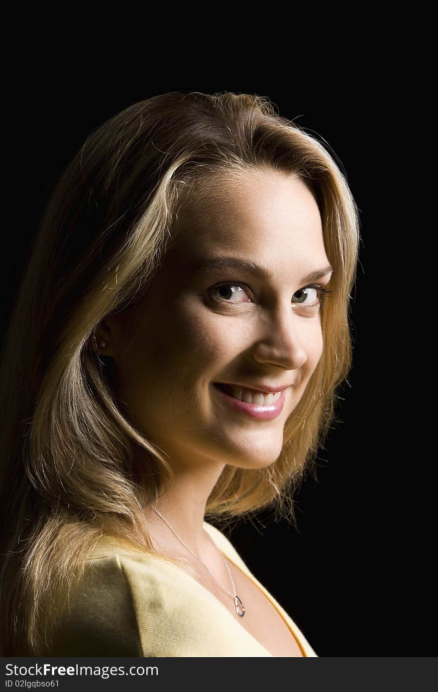 Portrait of an attractive young woman smiling towards the camera.  Vertical shot. Portrait of an attractive young woman smiling towards the camera.  Vertical shot.