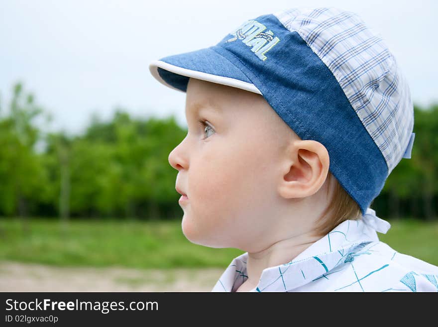 Little boy in the cap and green background