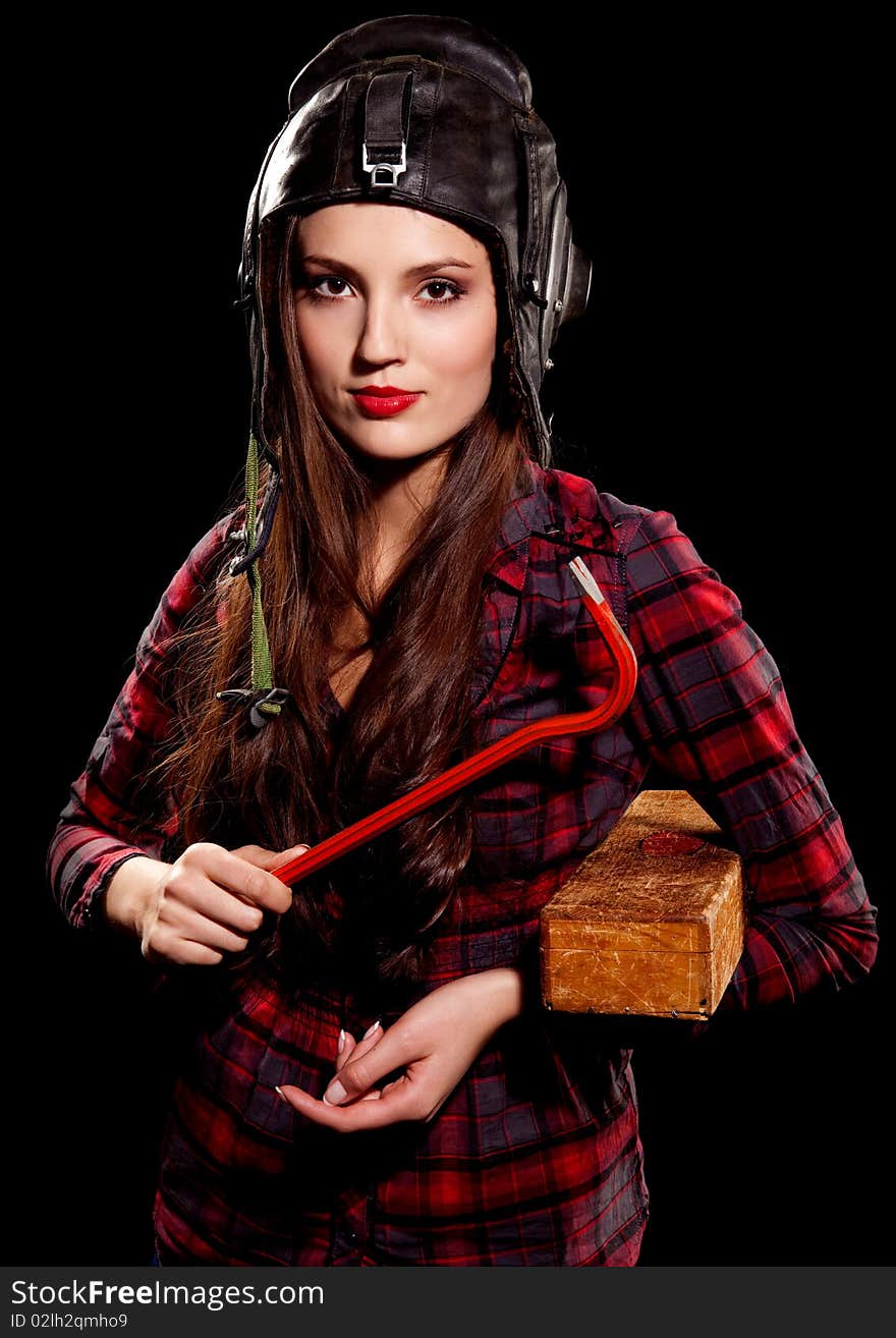 Young beautiful woman in cell shirt with red crowbar. Young beautiful woman in cell shirt with red crowbar