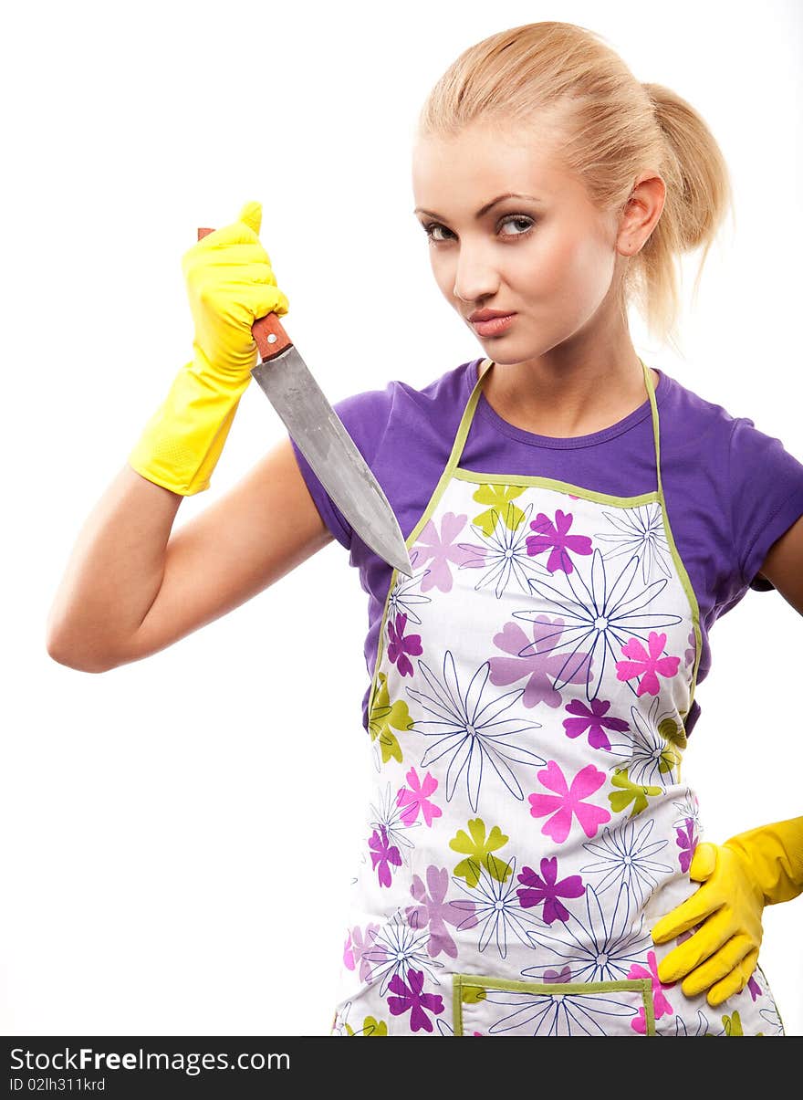 Young beautiful housewife in rubber yellow gloves with knife. Young beautiful housewife in rubber yellow gloves with knife