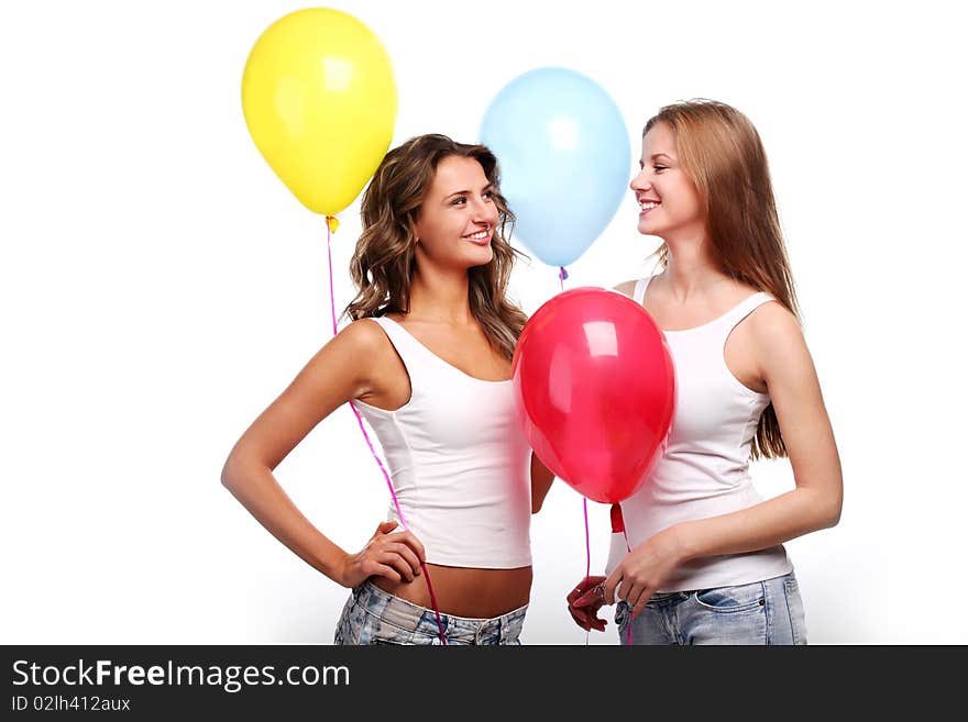 Two beautiful young girlfriends with color balloons. Two beautiful young girlfriends with color balloons