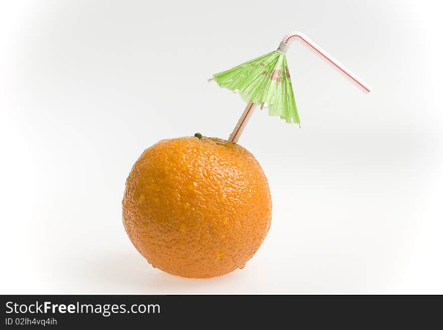 Orange with straw and umbrella isolated on white background