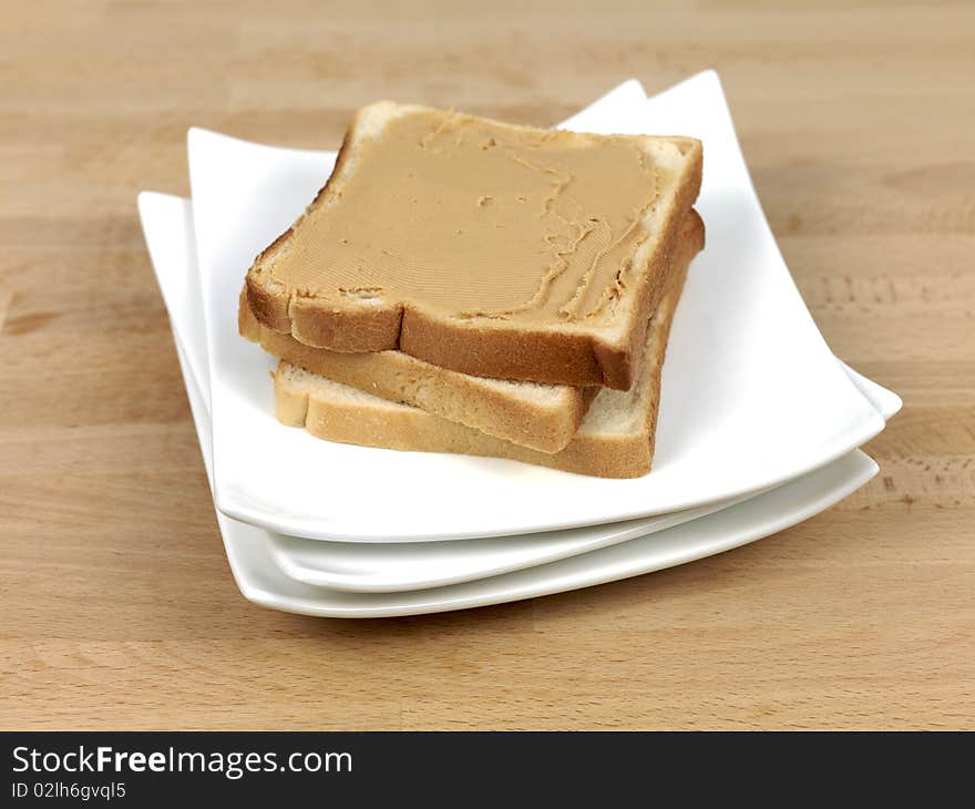 A slice of white bread with peanut butter