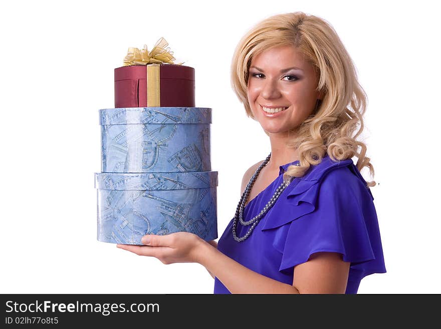 Beautiful smiling woman with a gift. Girl in purple dress is standing and holding purple box with gold ribbon on white background. Beautiful smiling woman with a gift. Girl in purple dress is standing and holding purple box with gold ribbon on white background.