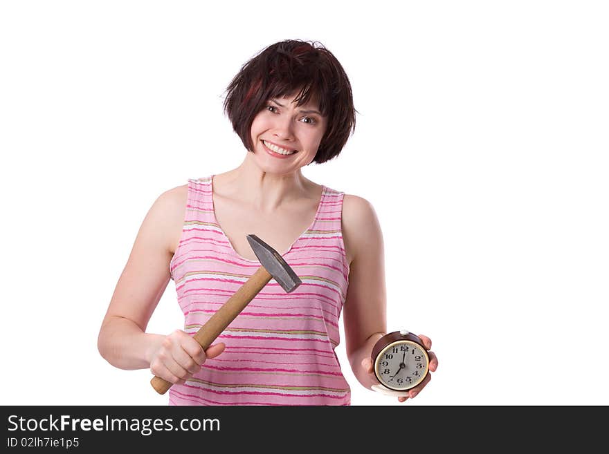 Sleepy woman is holding mallet and alarm clock at seven o'clock in the morning. A young woman looking like she just got out of bed. Photo of a young girl waking up in the early morning. Sleepy woman is holding mallet and alarm clock at seven o'clock in the morning. A young woman looking like she just got out of bed. Photo of a young girl waking up in the early morning.