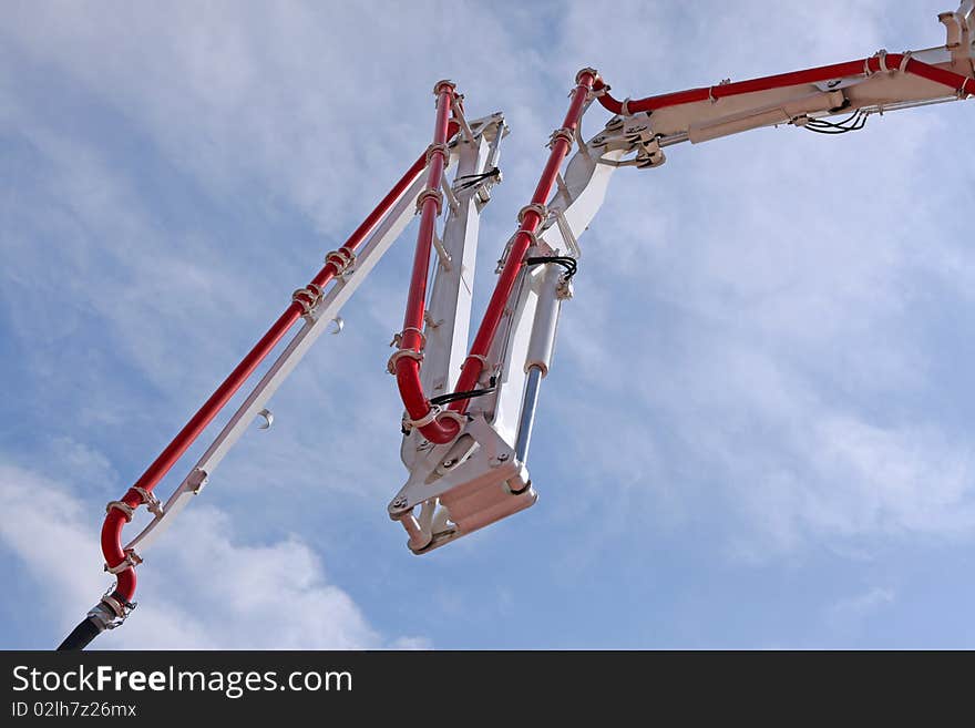 Concrete pump against the blue sky