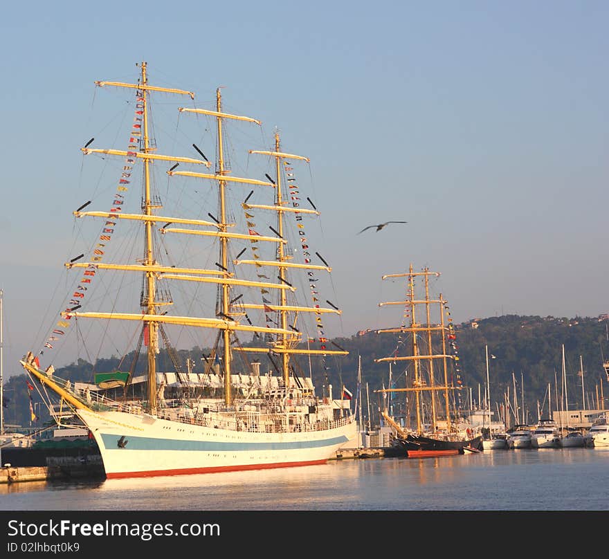 Tall sailing ships docking in a port