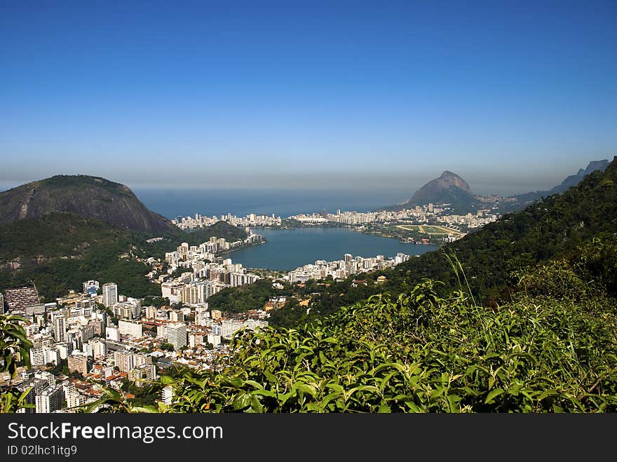 An aerial shot of rio de janeiro and the green around the city.Lagoa Rodrigo de Freitas, mostly known as Lagoa, is a lagoon and district in the Lagoa, Zona Sul (South Zone) of Rio de Janeiro. The lagoon is connected to the Atlantic, allowing sea water to enter, by a canal which is bordered by the park locally known as Jardim de Alá. An aerial shot of rio de janeiro and the green around the city.Lagoa Rodrigo de Freitas, mostly known as Lagoa, is a lagoon and district in the Lagoa, Zona Sul (South Zone) of Rio de Janeiro. The lagoon is connected to the Atlantic, allowing sea water to enter, by a canal which is bordered by the park locally known as Jardim de Alá.