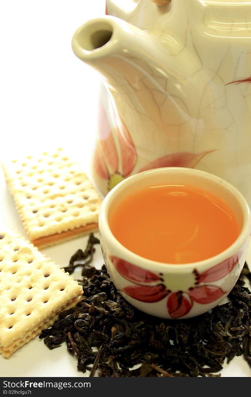 Ceramic tea pot and biscuit