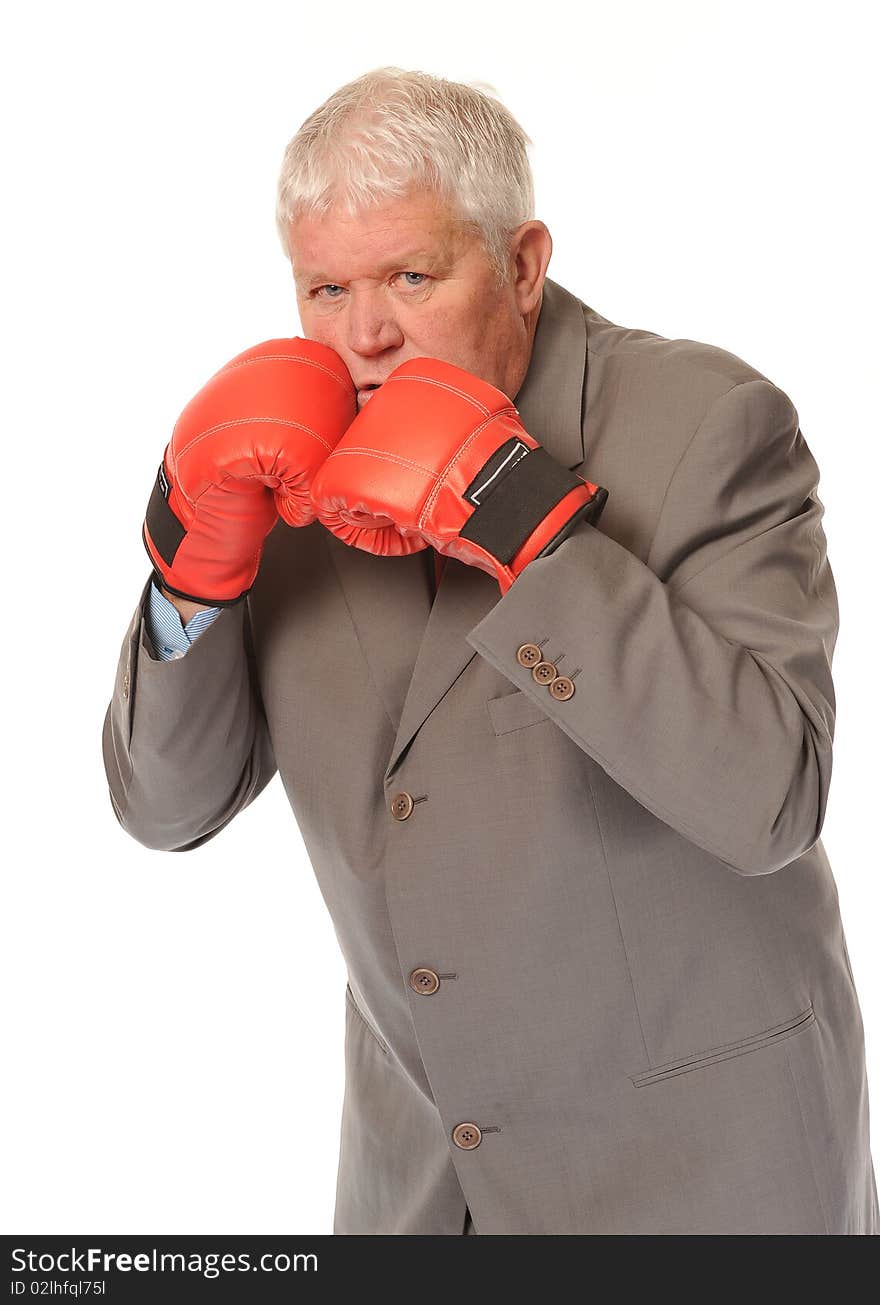 Successful mature business man on white background, boxing with red gloves. Successful mature business man on white background, boxing with red gloves