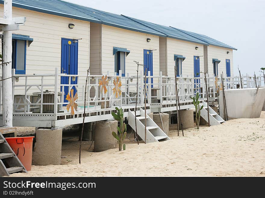 These are simple beach huts, big enough for a family.  They have a balcony and there are some cactus in front of them.