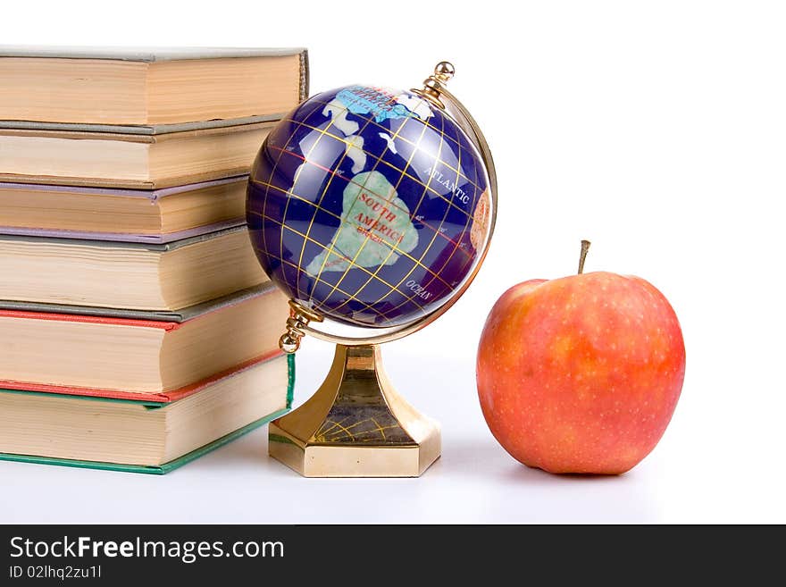 Apple, globe and books isolated on a white background