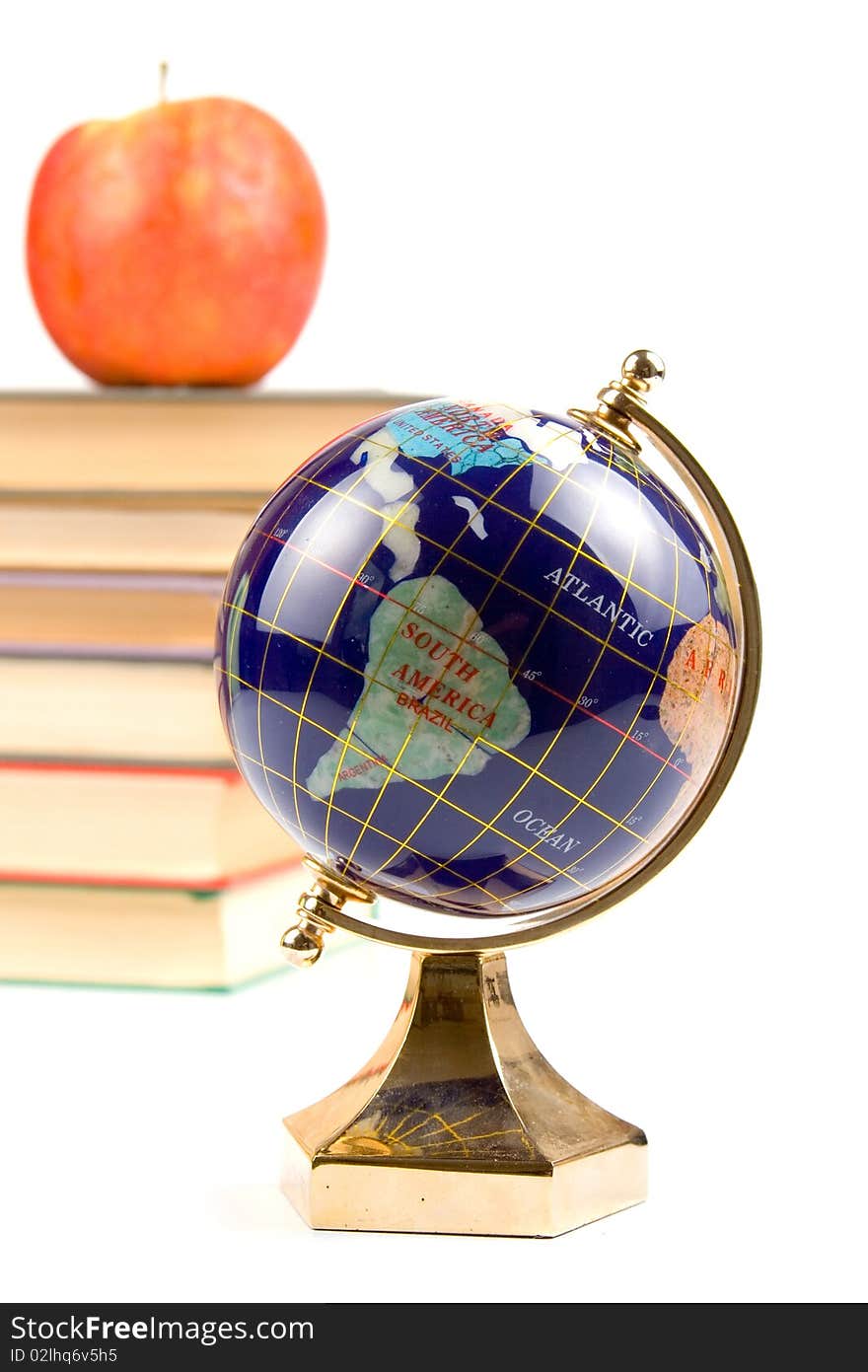 Apple, globe and books isolated on a white background