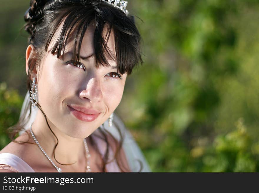 Portrait of beautiful young bride in vineyard.