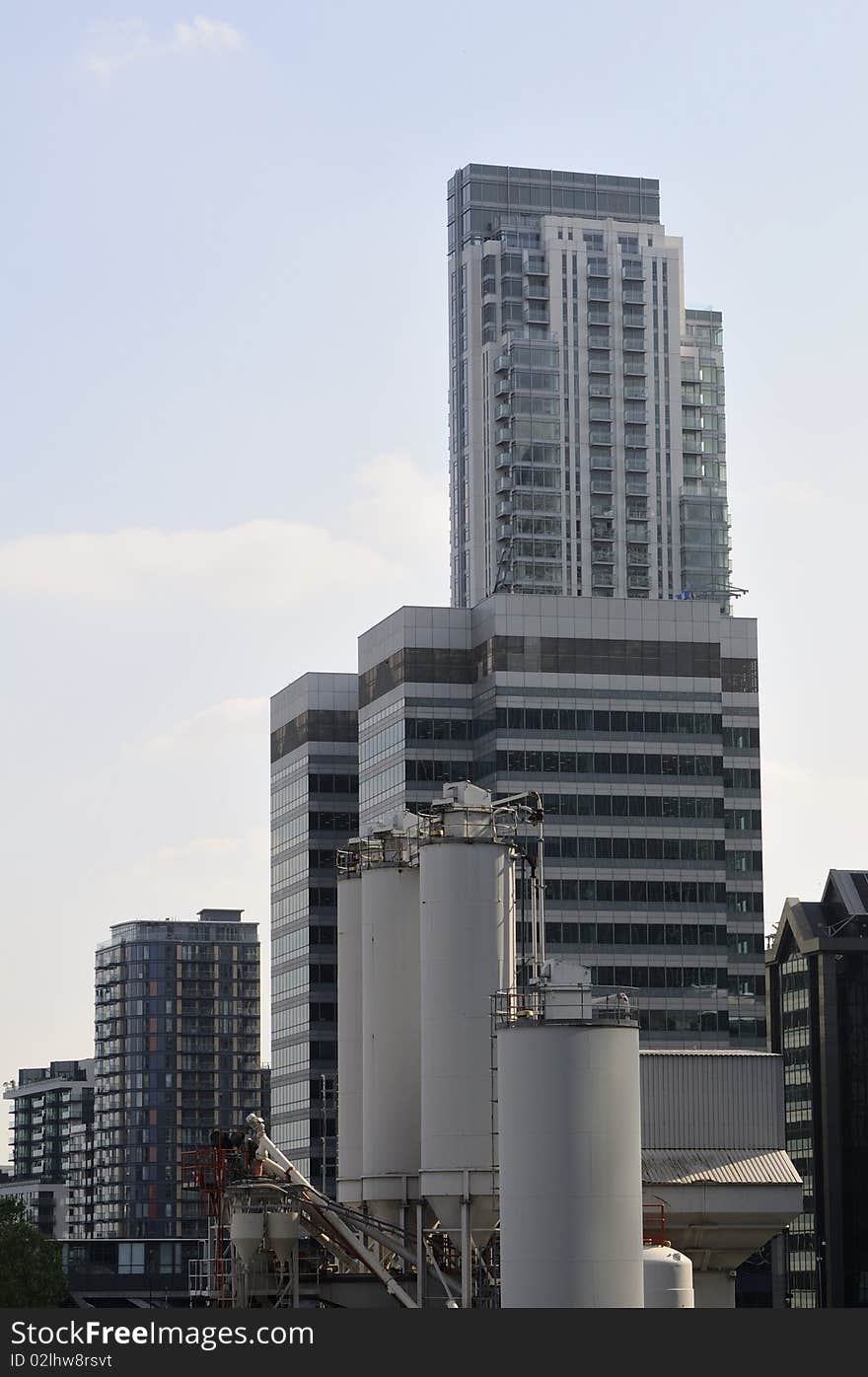 Vertical building with offices located in London UK, blue sky in background. Vertical building with offices located in London UK, blue sky in background