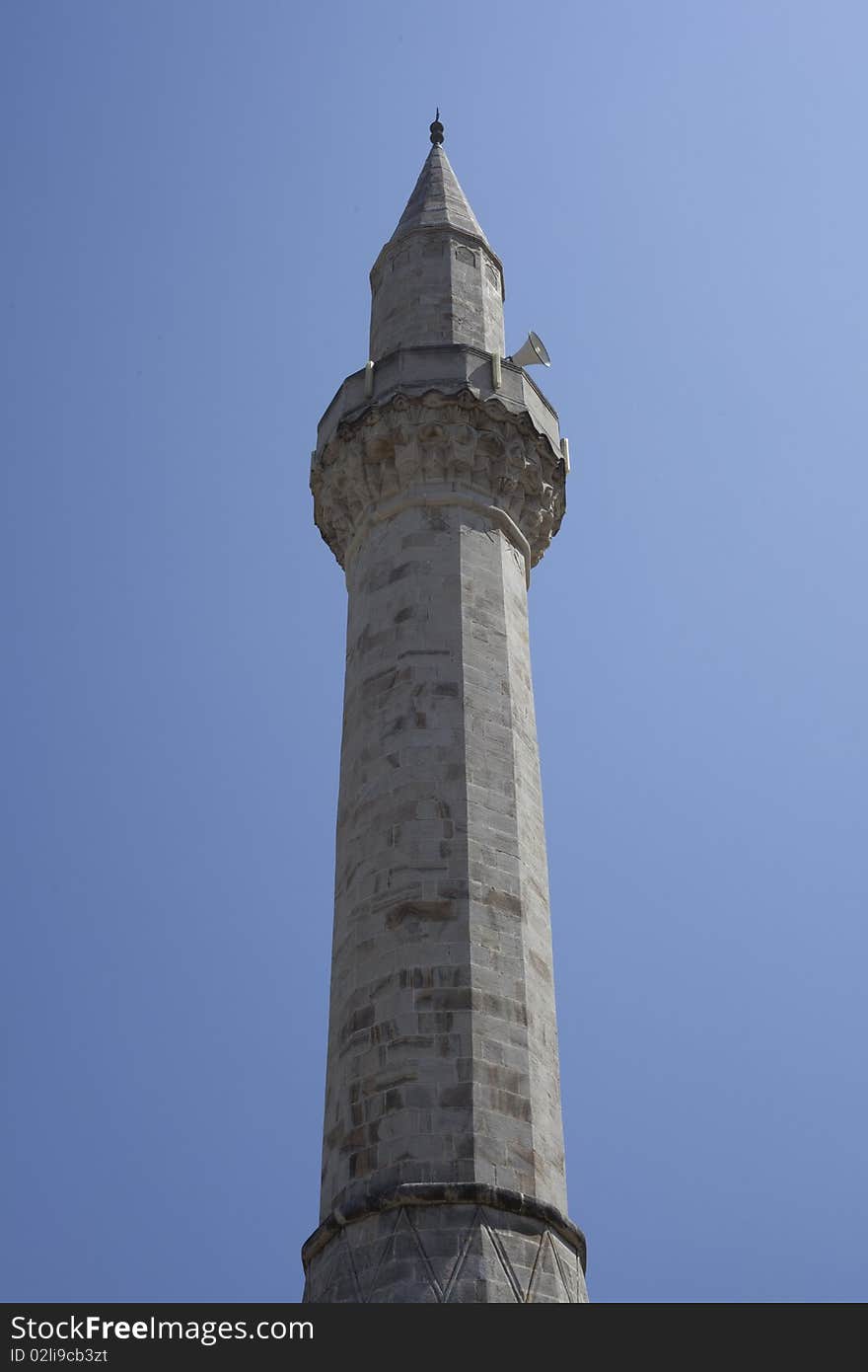 Bosnian minaret, towering over mostar's blue sky