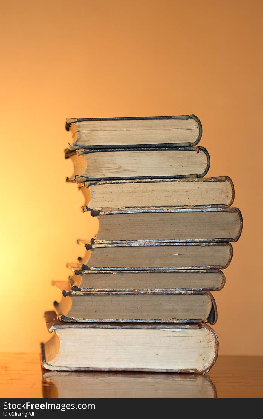 Stack of ancient books isolated on gradient yellow background. Stack of ancient books isolated on gradient yellow background