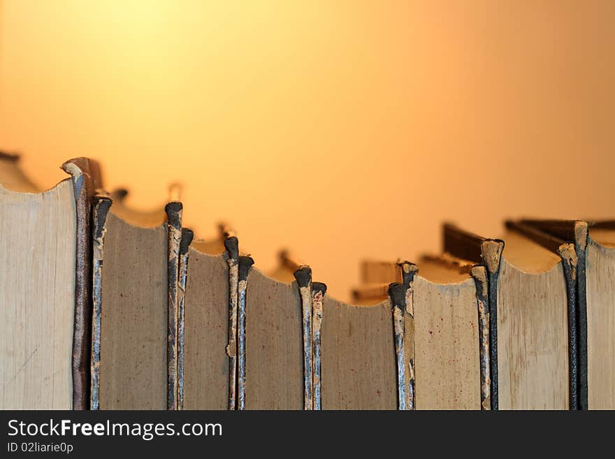 Stack of ancient books isolated on gradient yellow background. Stack of ancient books isolated on gradient yellow background