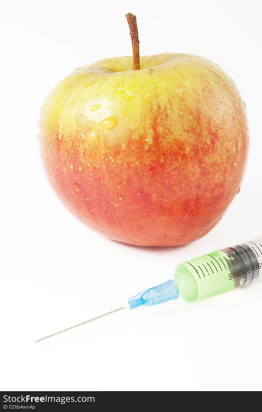 Apple and syringe. genetic modification food