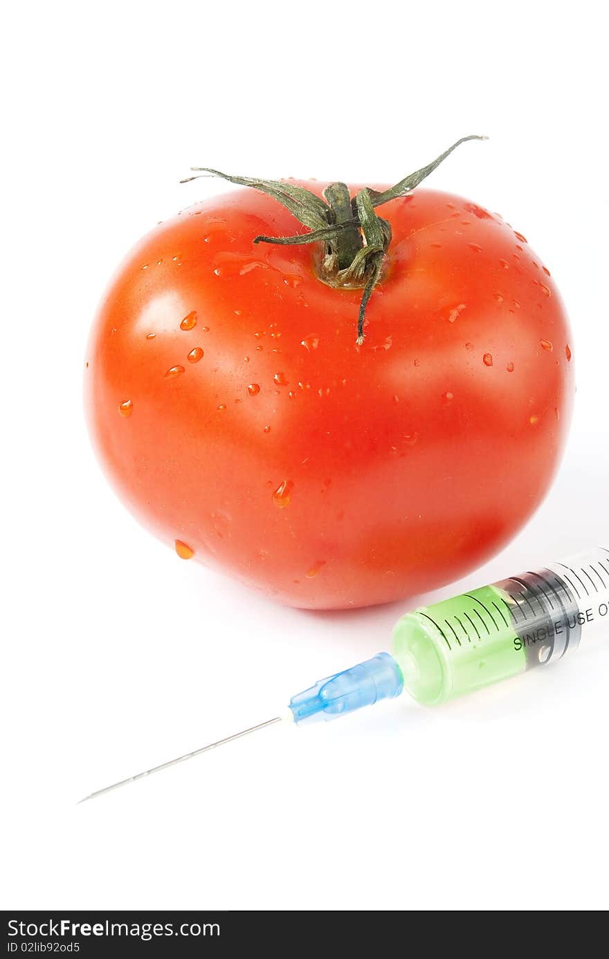 Tomato with syringe over white