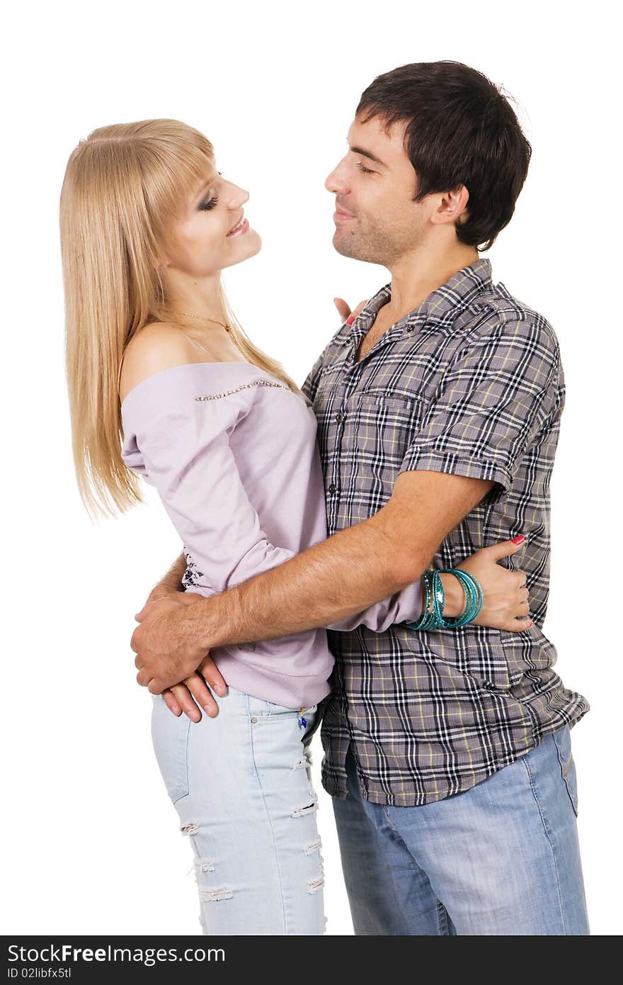 Romantic young couple in casual clothing, white background. Romantic young couple in casual clothing, white background