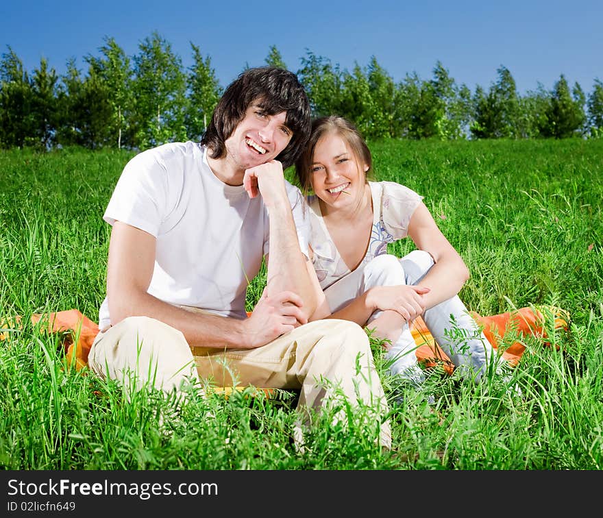 Beautiful girl and boy on grass