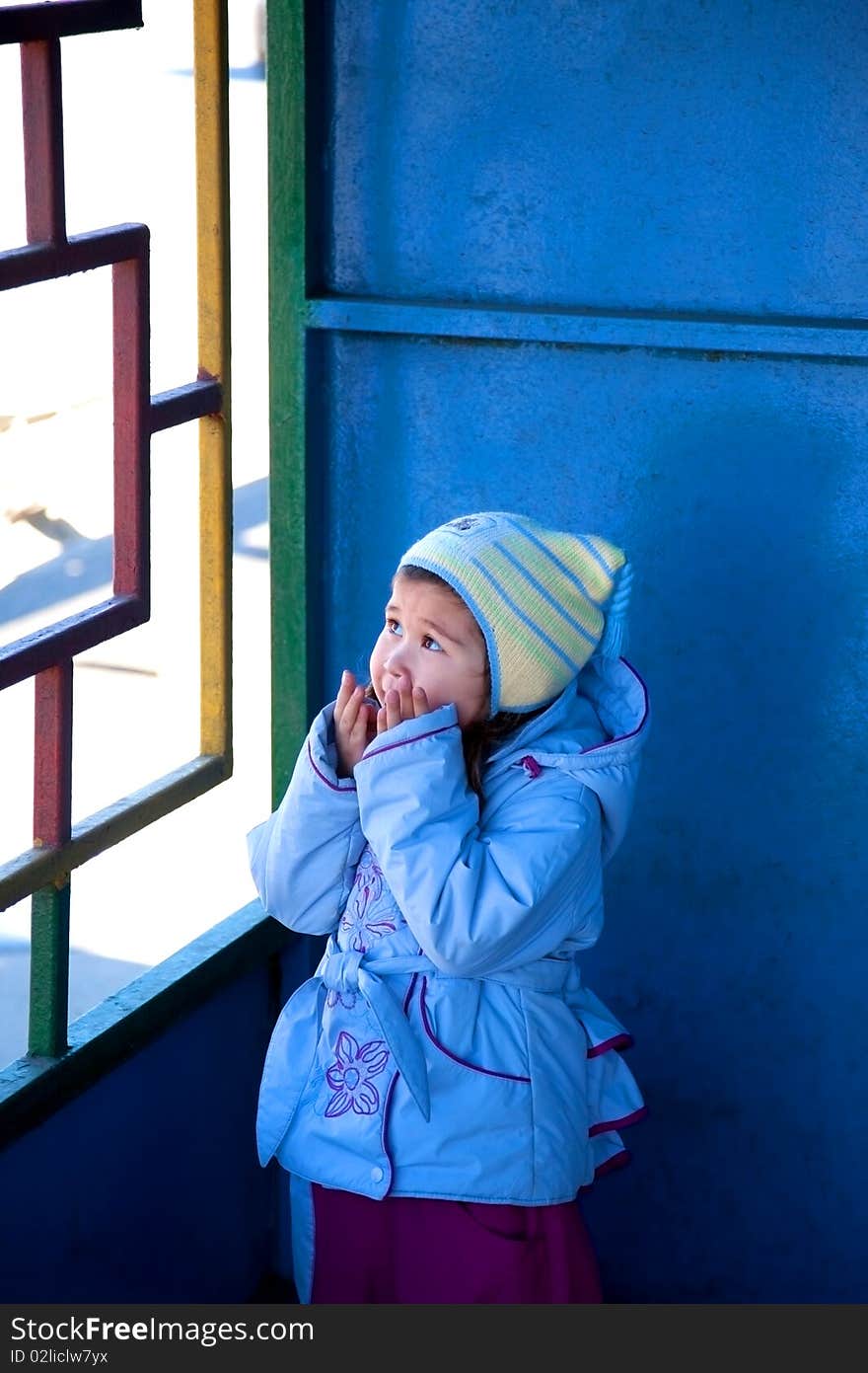 Girl looking up with hands ready to hide her face