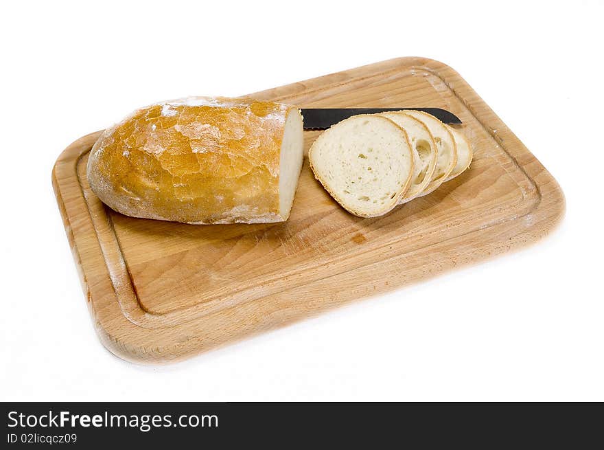 Partially sliced bread on a wooden board