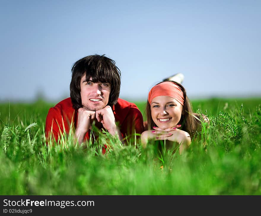 Girl in kerchief and boy on grass