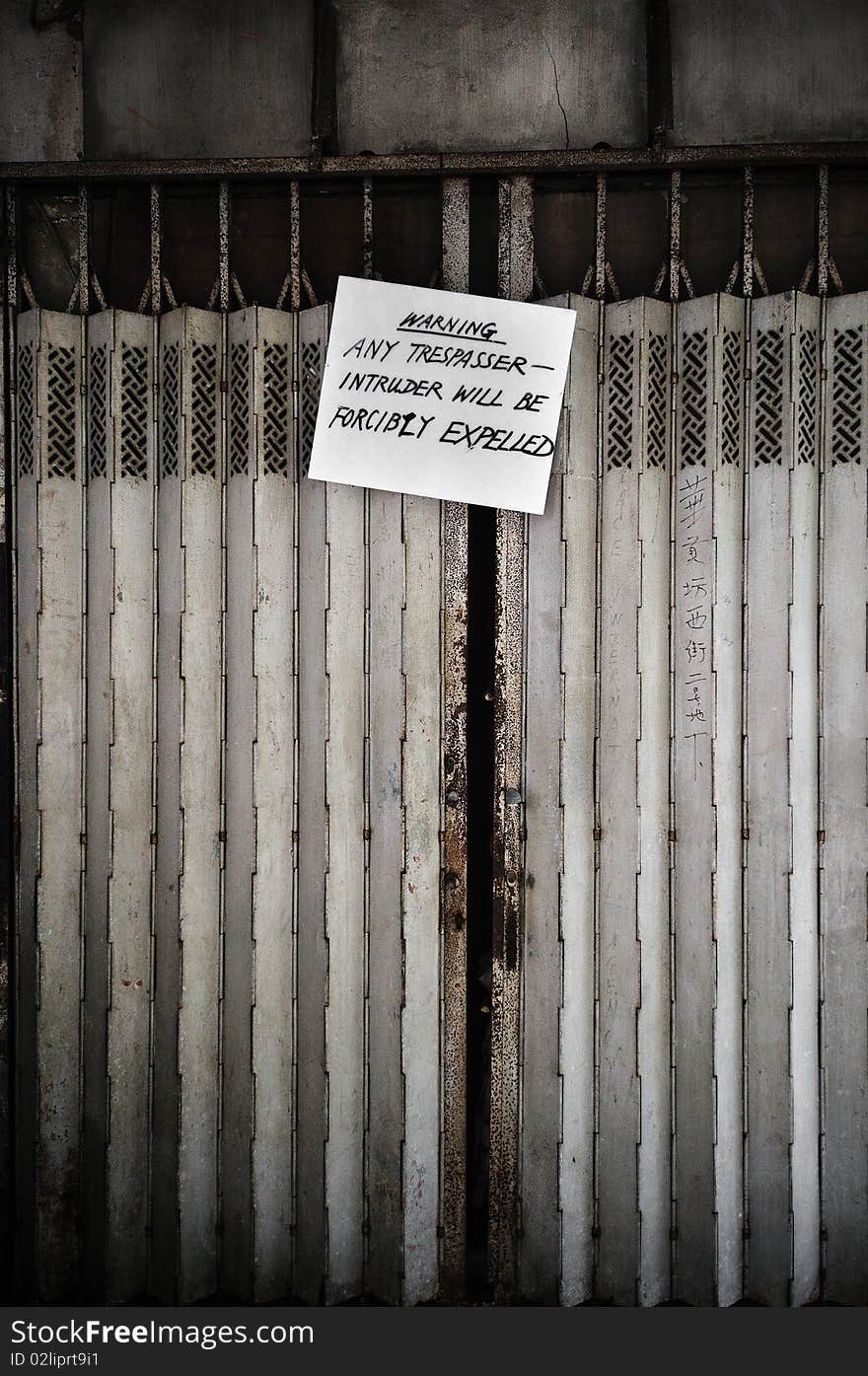 Shot in Central, Hong Kong. Warning sign on the shutters of an abandoned building. Part of the Staunton Street redevelopment project. Shot in Central, Hong Kong. Warning sign on the shutters of an abandoned building. Part of the Staunton Street redevelopment project.