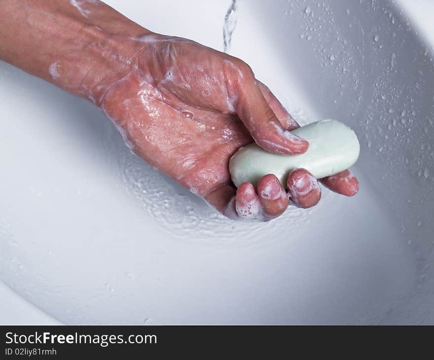 Man hand holding soap under water. Man hand holding soap under water