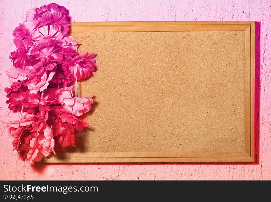 Floral frame of wood with fake plastic flowers