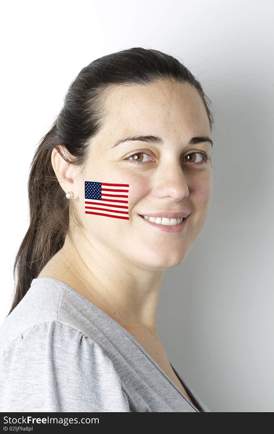 American fan with a painted flag on her face. American fan with a painted flag on her face.