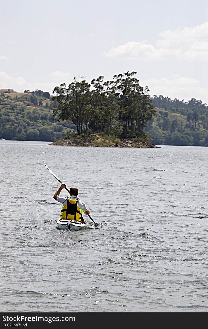 Man enjoying a morning in a dam kayaking. Man enjoying a morning in a dam kayaking