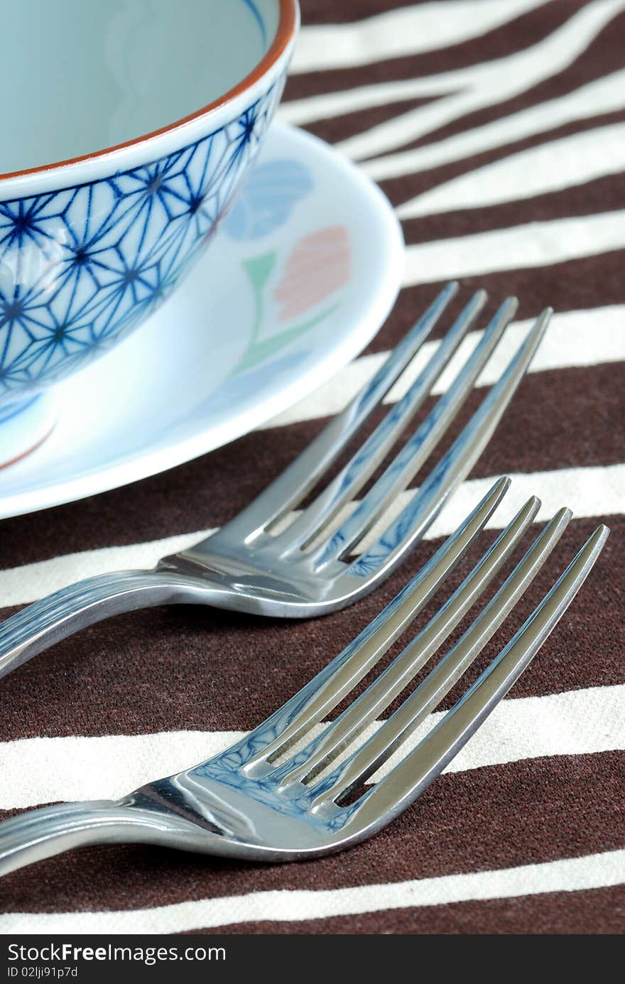 Getting ready for the meal time with utensil on the placemat.