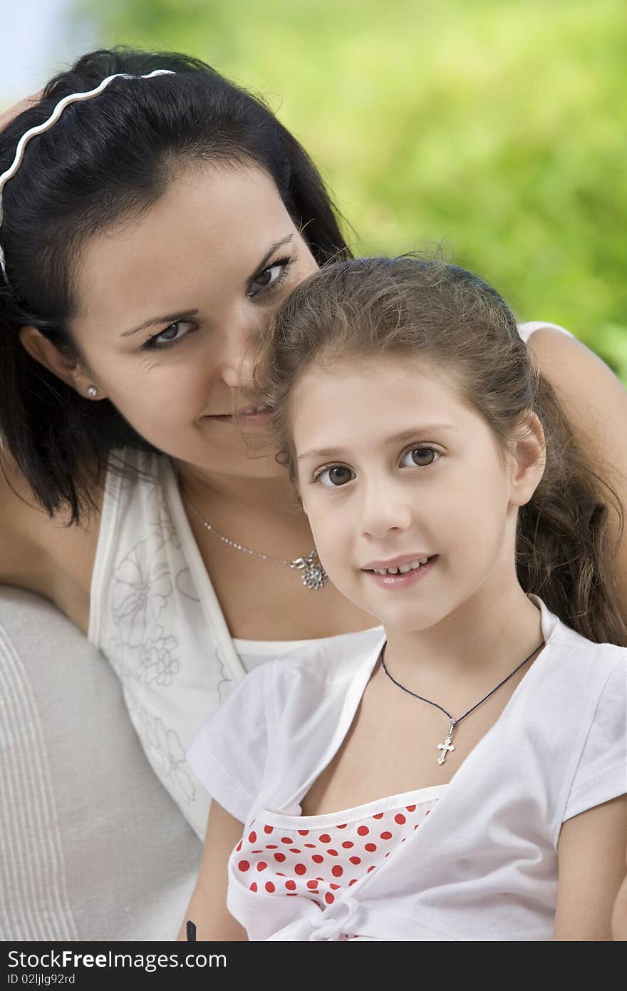 Portrait of happy mother with daughter  having good time in summer environment. Portrait of happy mother with daughter  having good time in summer environment