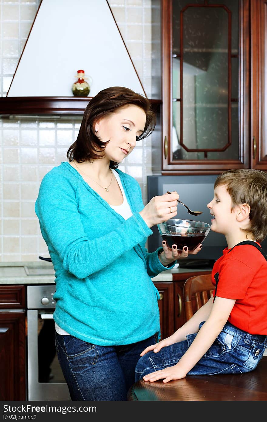 Happy pregnant woman with her son at home. Happy pregnant woman with her son at home.