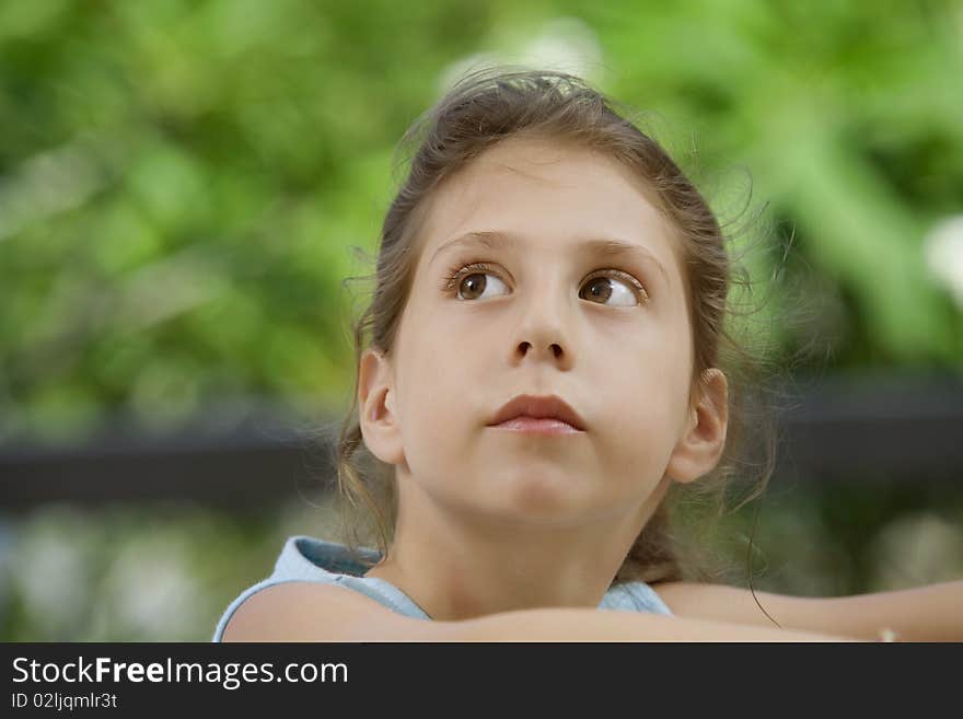 Portrait of nice little girl in summer environment