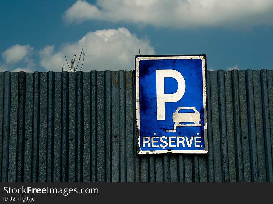 Parking sign and blue sky with white clouds. Parking sign and blue sky with white clouds