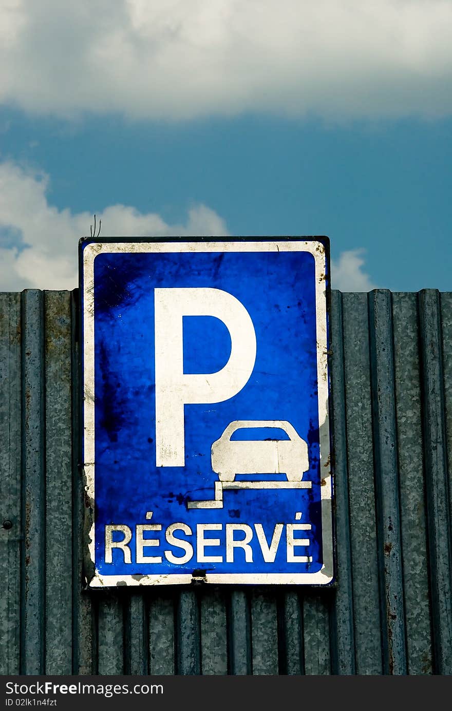 Parking sign and blue sky with white clouds. Parking sign and blue sky with white clouds