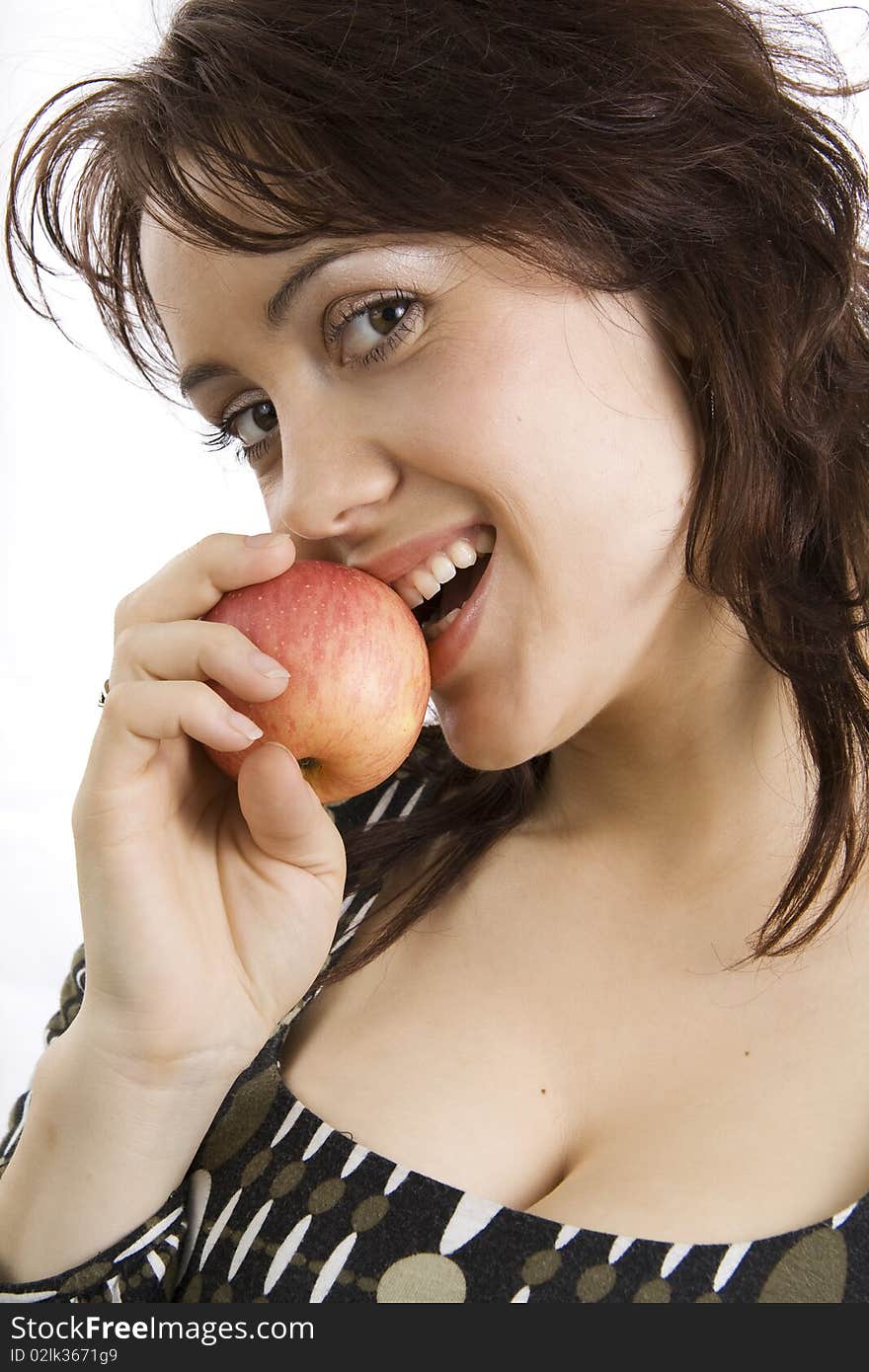 The beautiful young woman eats an apple