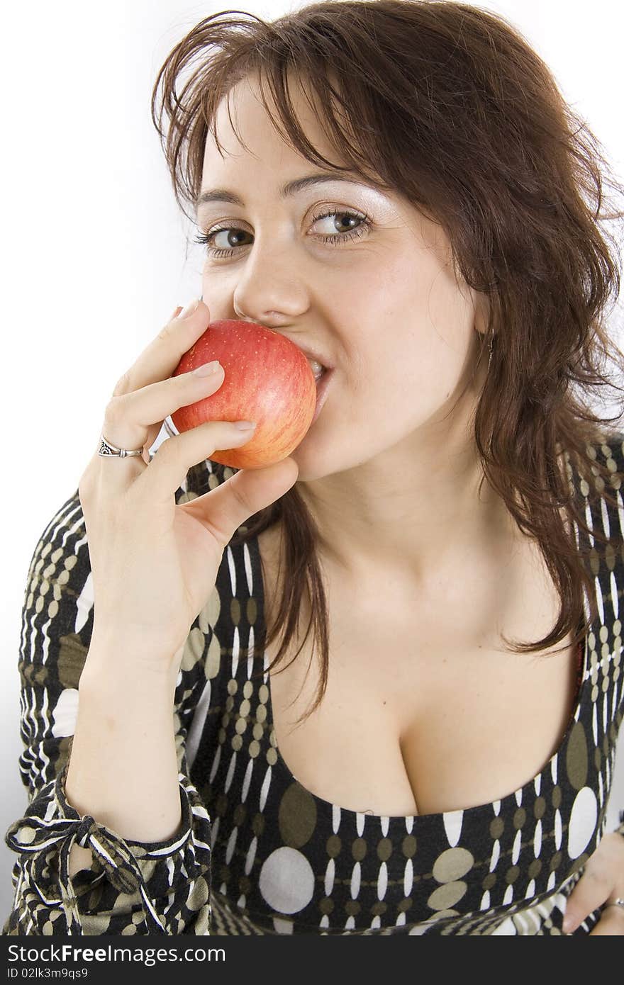 The beautiful young woman eats an apple