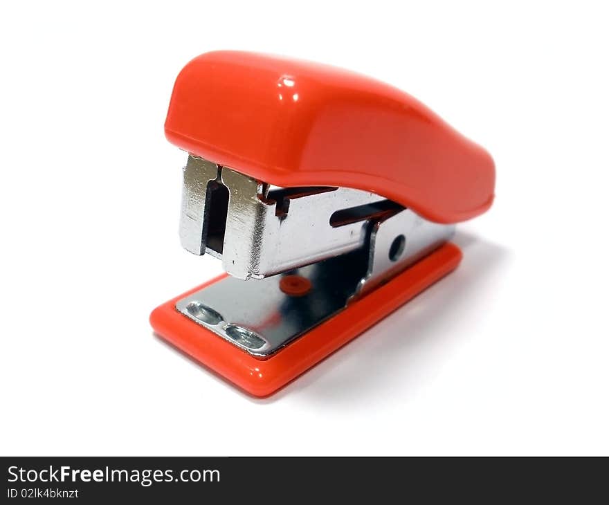 Small red stapler on the white backgraund