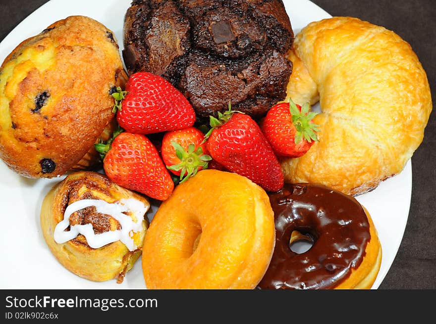 Snake plate with strawberries and donuts. Snake plate with strawberries and donuts.