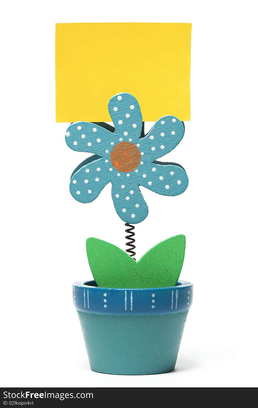 Blue wooden flower with yellow note isolated. Blue wooden flower with yellow note isolated