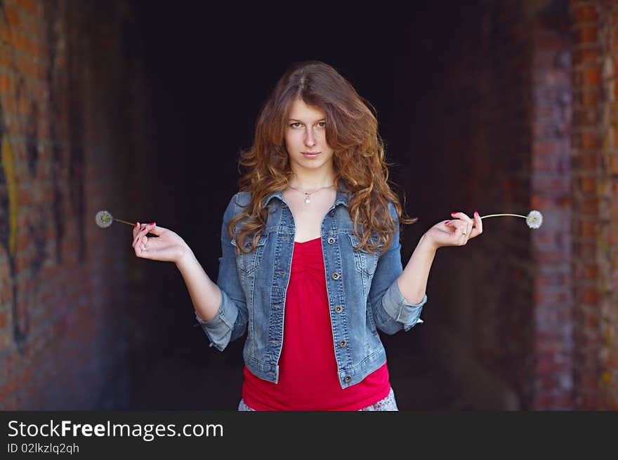 Young girl with two dandelions