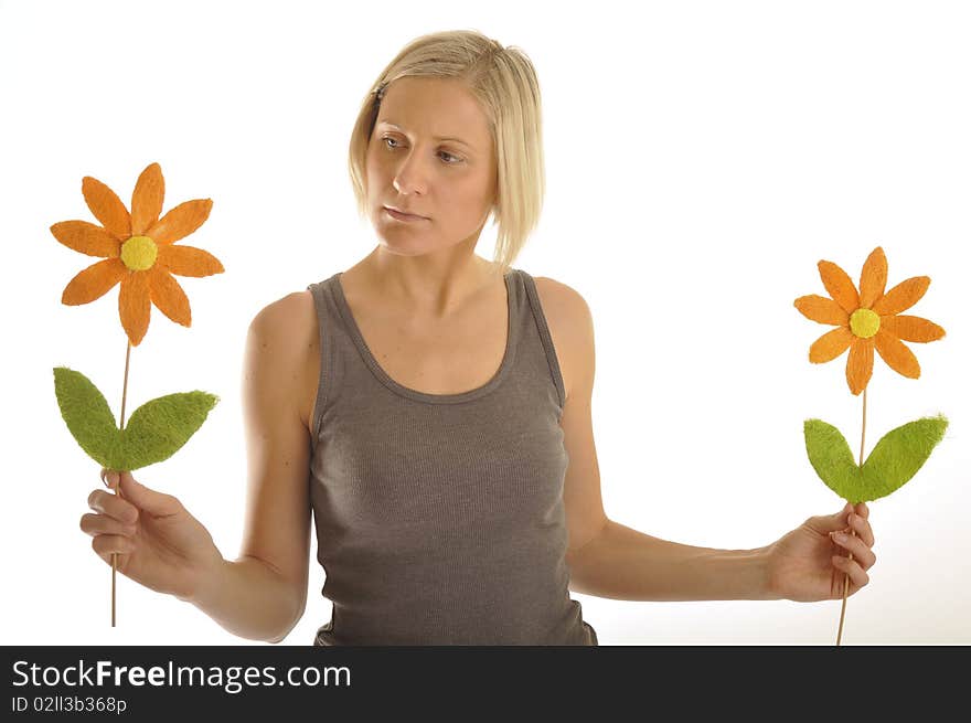 Young lady has a problem chosing a flower. Young lady has a problem chosing a flower